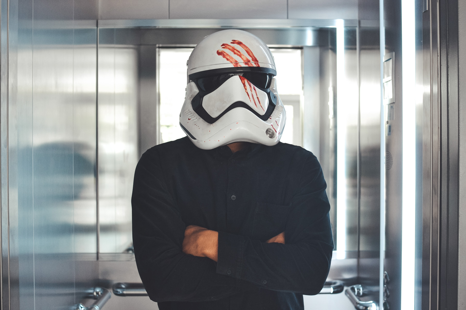 A person wearing a stormtrooper helmet 3d printed on a voxeljet machine